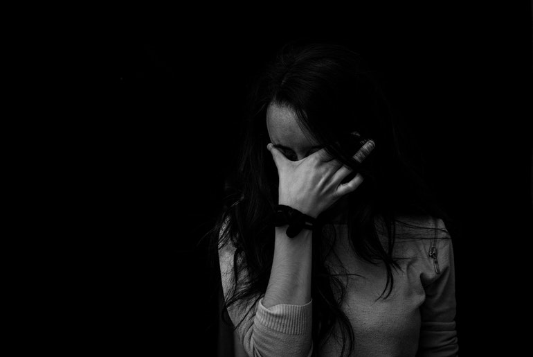 Black and white photo of a sad woman