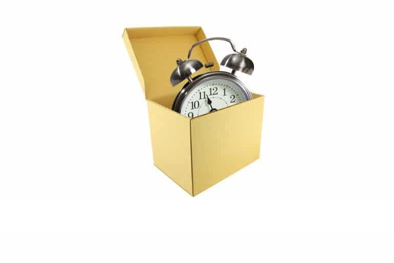 Picture of an alarm clock in a cardboard box