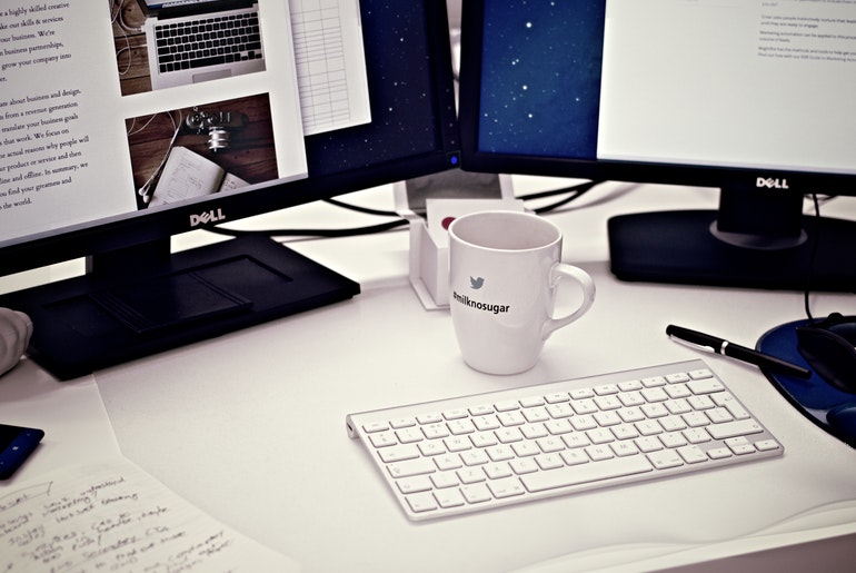 White Ceramic Mug On Computer Desk