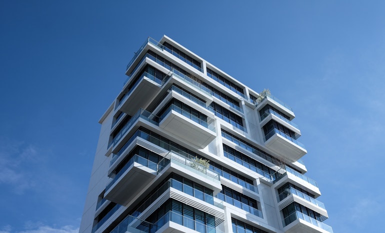 White apartment block against a blue sky