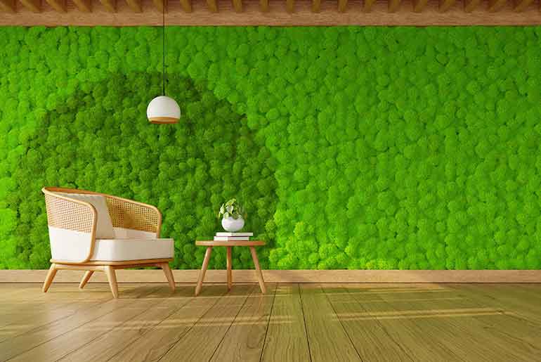 Stylish armchair with a green moss wall