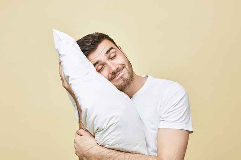 Man hugging a pillow