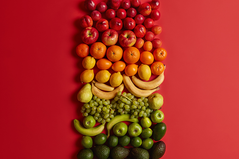 Range of healthy fruits on a red background