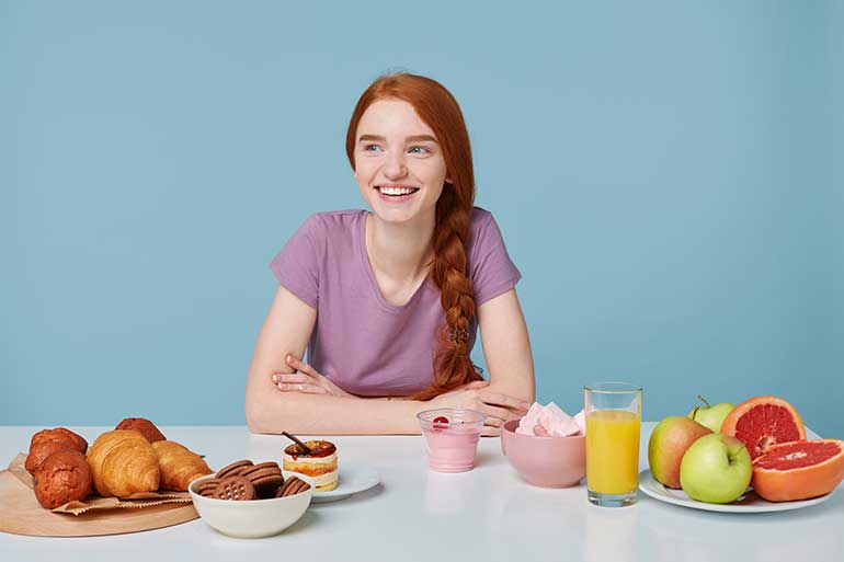 Smiling girl about to eat breakfast