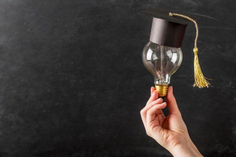 Lightbulb with a graduation cap on it