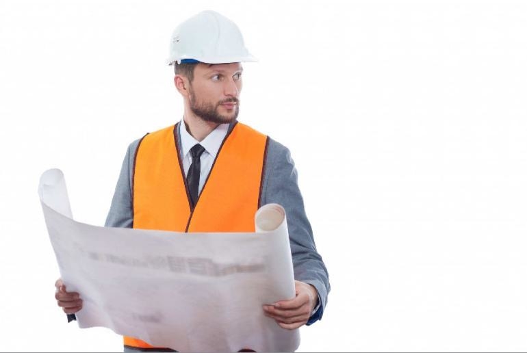 Engineer holding plans, wearing an orange hi-vis vest