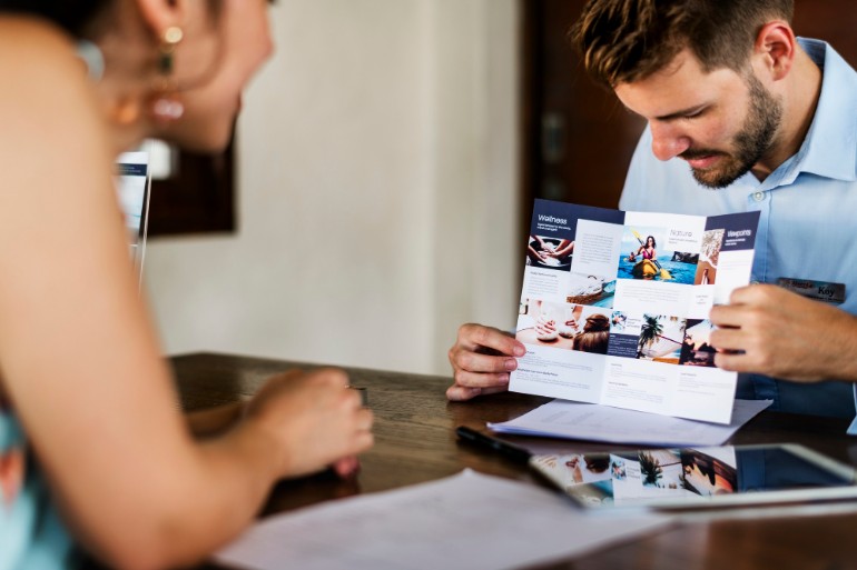 Two people looking at a brochure design