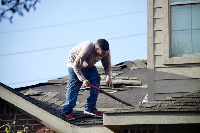 Photo of person performing a roof repair