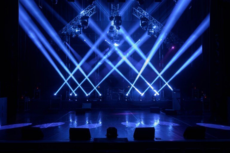 Stage with blue lights criss-crossing it