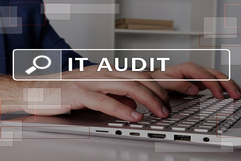 Person typing on a laptop with "IT Audit" search term superimposed over it