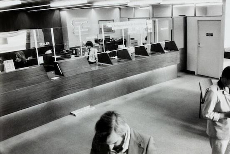 Black and white photo of the interior of a bank