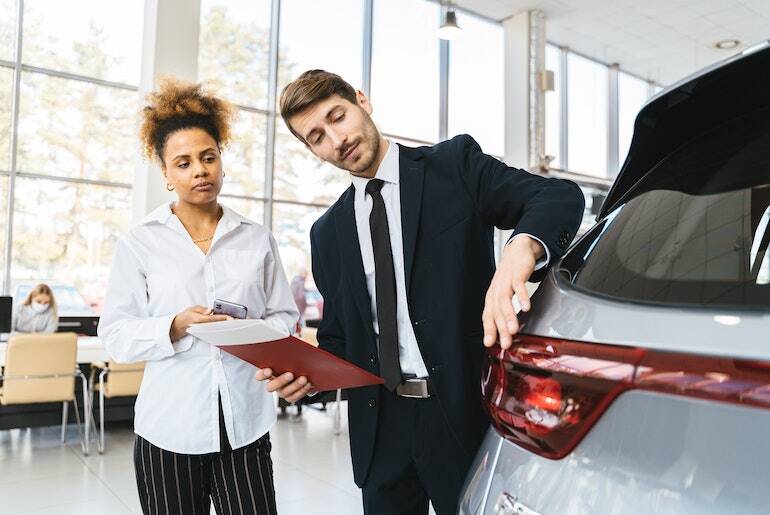Person looking at a car in a car showroom