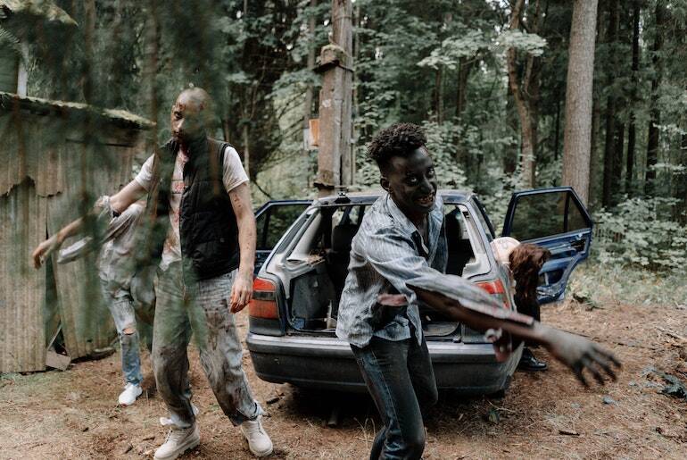 Two zombies outside a wooden cabin and absconded car