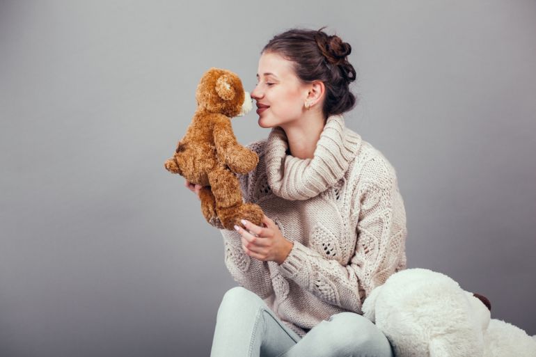 Woman holding a worn looking stuffed animal