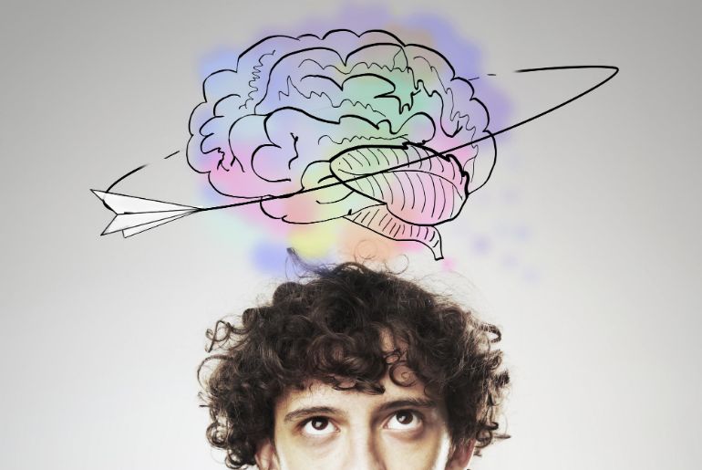 Person with a drawing of a brain above their head being circled by a paper airplane