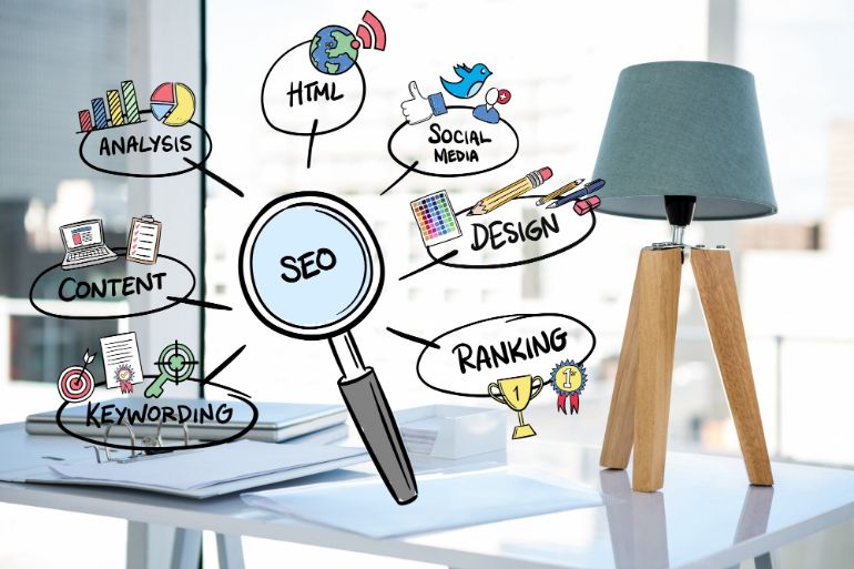 A photo of a desk with a tripod lamp on it with an illustration of SEO principles in front of it