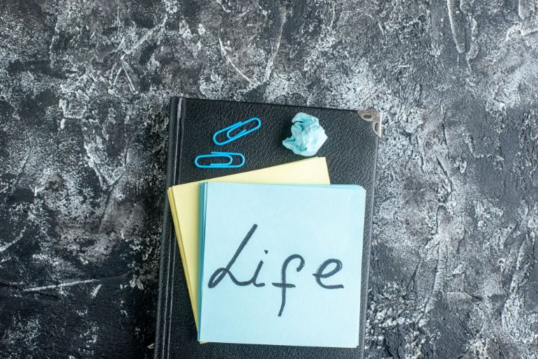 A planner with the word "life" written on paper