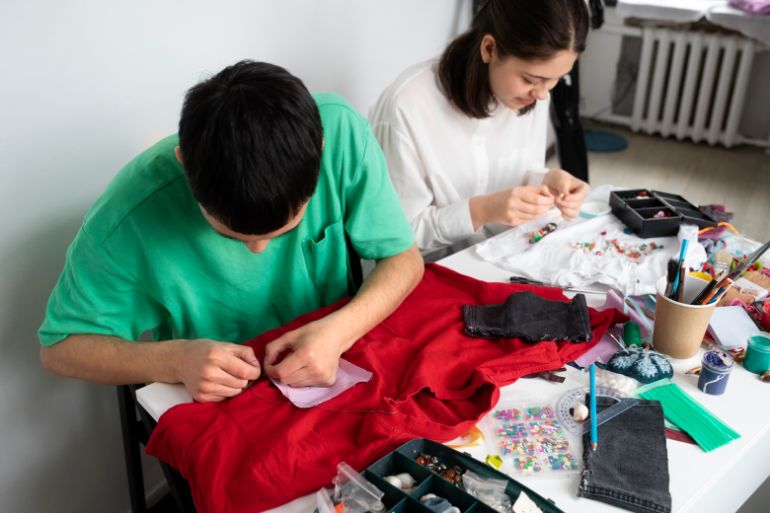 Two people working on garments